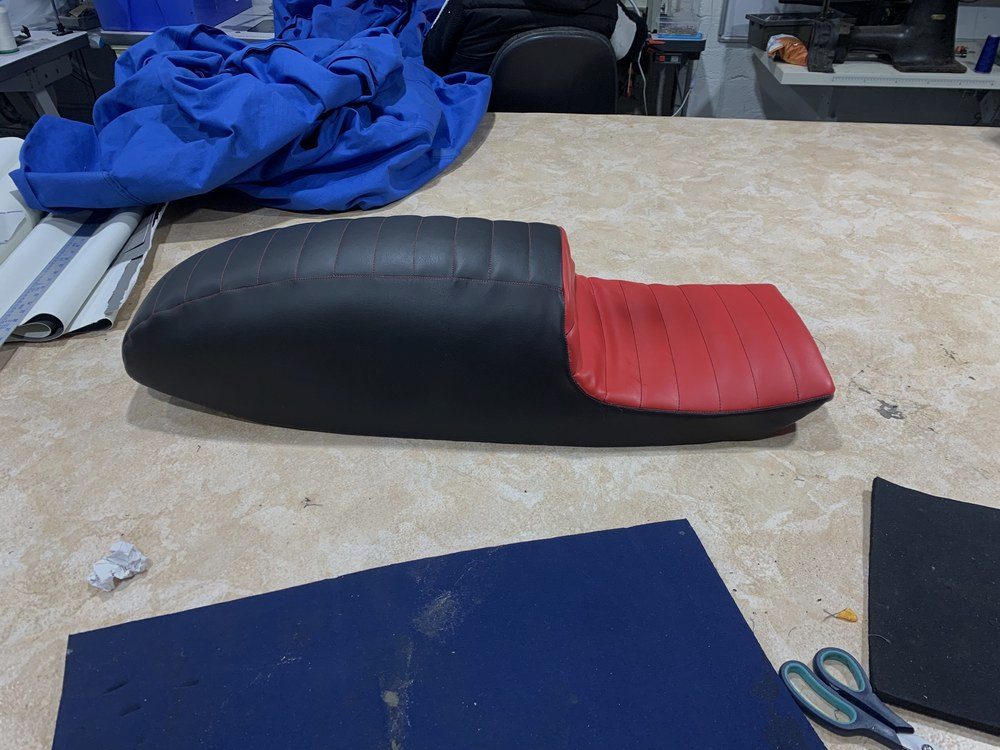 Motorcycle seat part-recovered on the workshop bench
